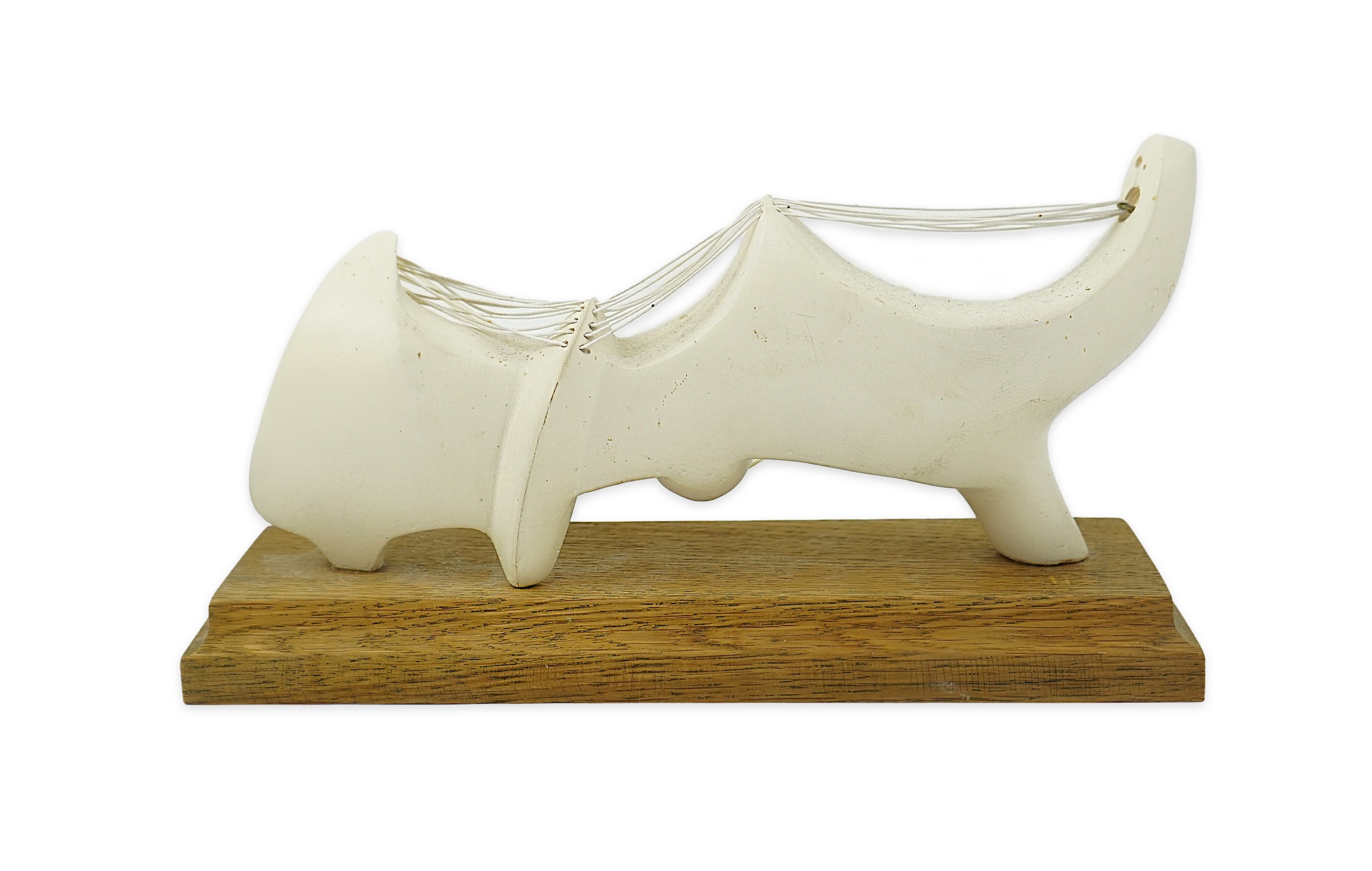 Follower of Henry Moore (1898-1986) A modernist stringed plaster sculpture raised on an oak rectangular plinth base, 25cm wide